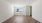 large room with wood floors and lighting