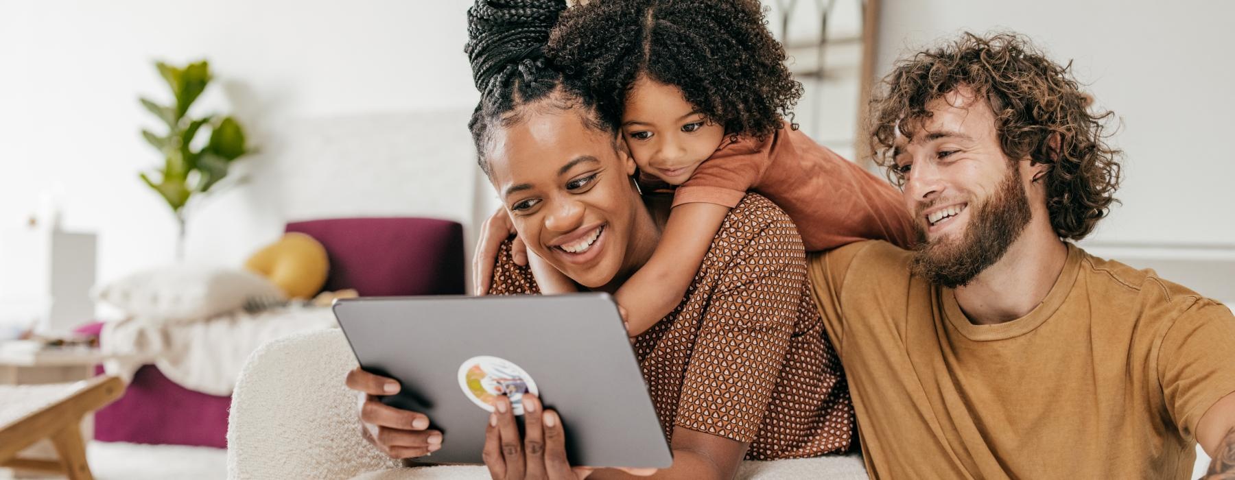 a man and woman looking at a tablet