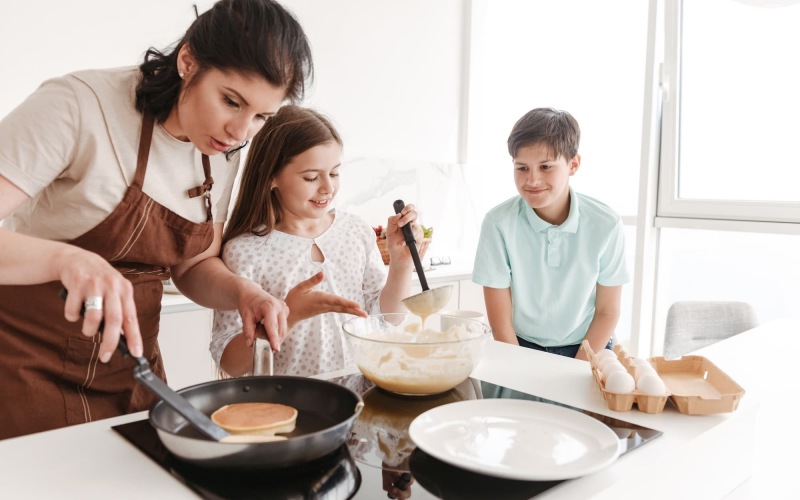 a mother cooking with her kids